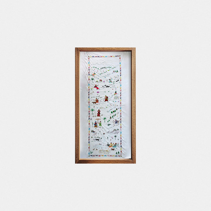 Framed artwork with a colorful design on a white wall