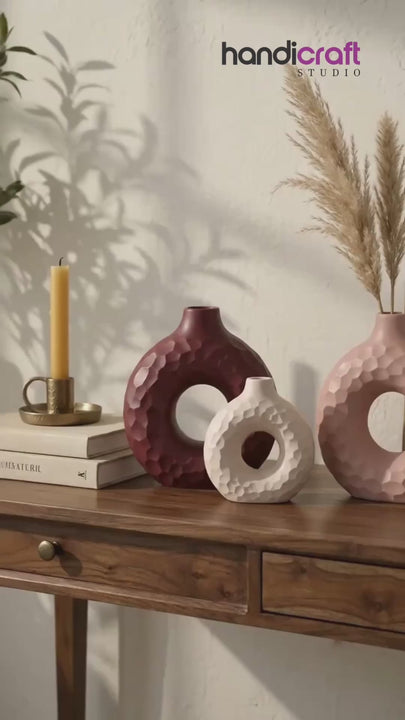 Bold donut vase ceramic form standing alone in a bright minimalist interior