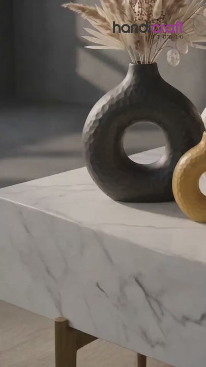 Donut ceramic vase resting on a kiln shelf after being fired slowly at high heat