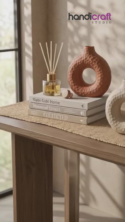 Solid colour donut vase set arranged in a row inside an elegant Indian home